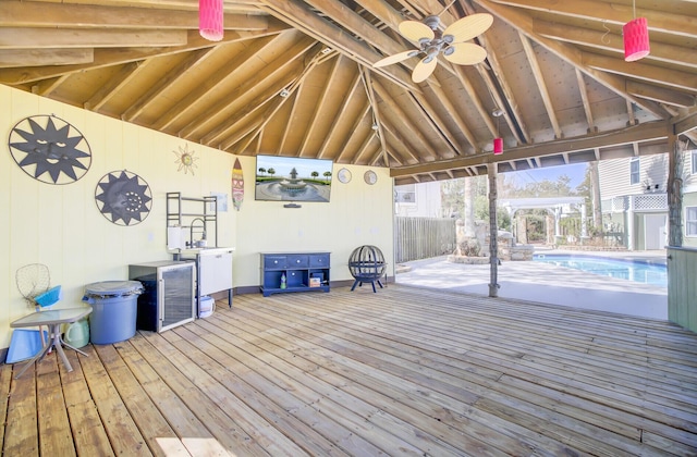 deck featuring fence and an outdoor pool