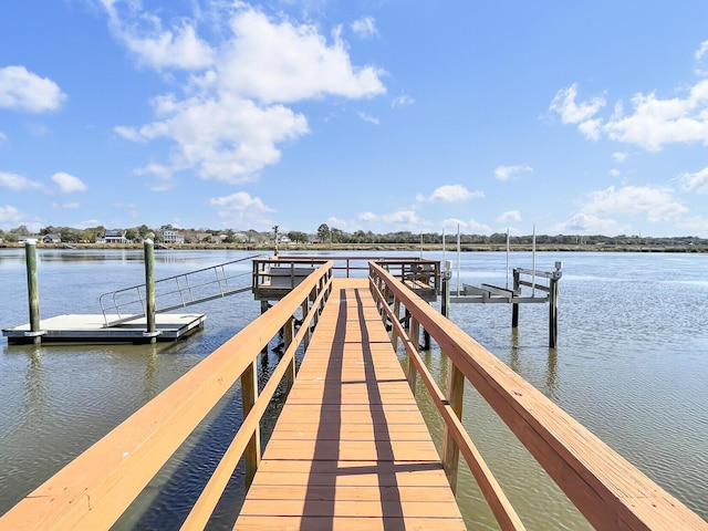 dock area with a water view and boat lift