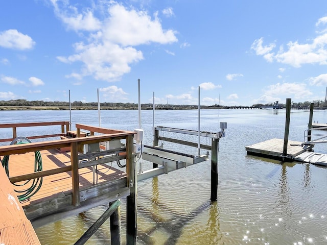 view of dock featuring boat lift and a water view