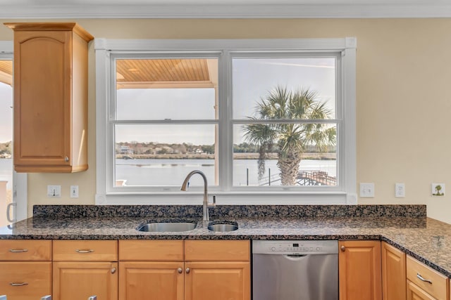 kitchen featuring dark stone counters, ornamental molding, a sink, a water view, and stainless steel dishwasher