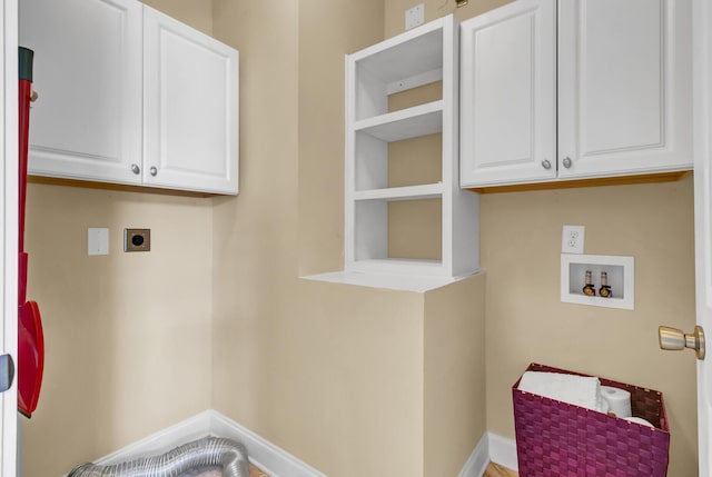 clothes washing area with built in shelves, baseboards, hookup for a washing machine, cabinet space, and electric dryer hookup