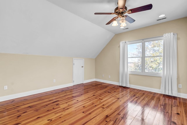 bonus room with lofted ceiling, baseboards, visible vents, and wood-type flooring