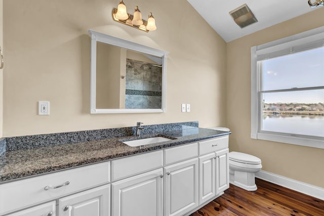 bathroom featuring visible vents, toilet, wood finished floors, baseboards, and vanity