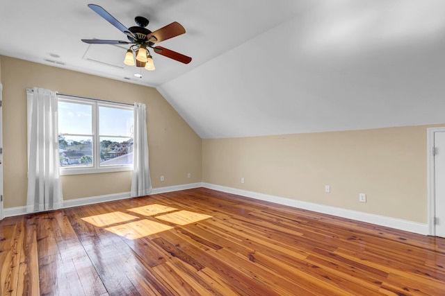 bonus room featuring lofted ceiling, a ceiling fan, baseboards, and wood-type flooring