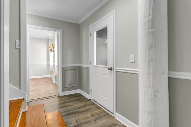 hall featuring baseboards, dark wood-style floors, and ornamental molding