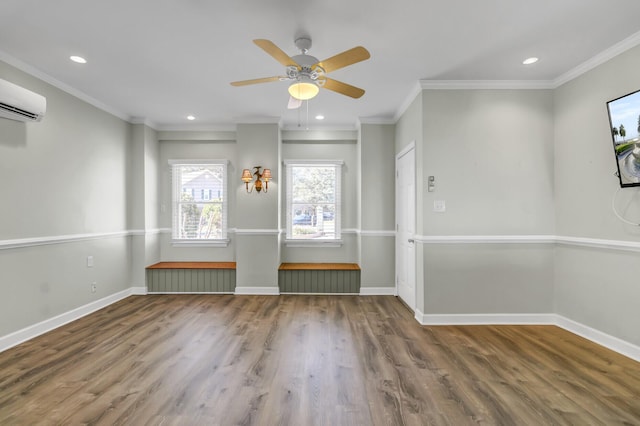 spare room featuring recessed lighting, wood finished floors, baseboards, and a wall mounted AC