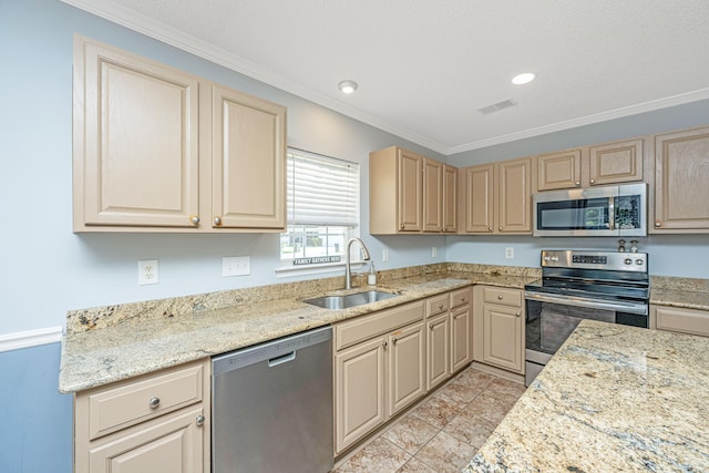 kitchen with light brown cabinets, sink, light stone countertops, ornamental molding, and appliances with stainless steel finishes