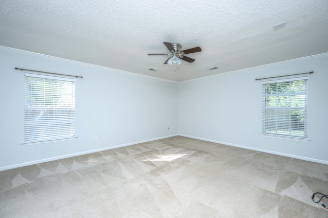 unfurnished room featuring light carpet, plenty of natural light, and ceiling fan