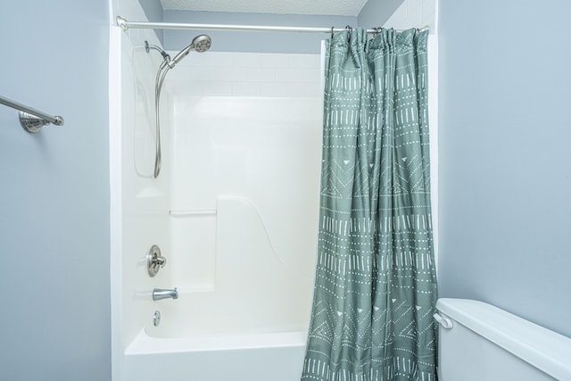 bathroom with shower / tub combo and toilet