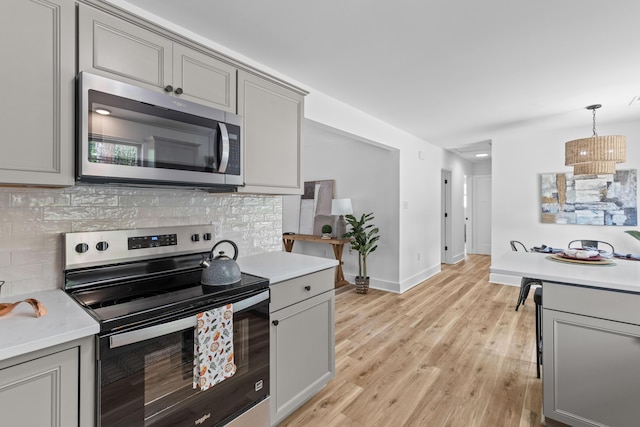 411 Berkeley Dr, Moncks Corner, SC 29461 - kitchen featuring appliances with stainless steel finishes, gray cabinetry, backsplash, and light countertops