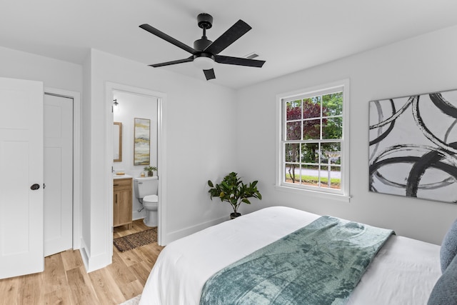 411 Berkeley Dr, Moncks Corner, SC 29461 - bedroom with light wood finished floors, baseboards, ensuite bath, and ceiling fan