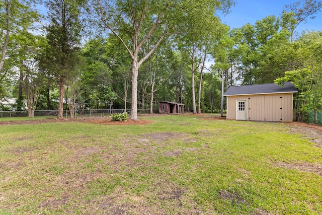 411 Berkeley Dr, Moncks Corner, SC 29461 - view of yard featuring a storage unit, an outbuilding, and view of wooded area