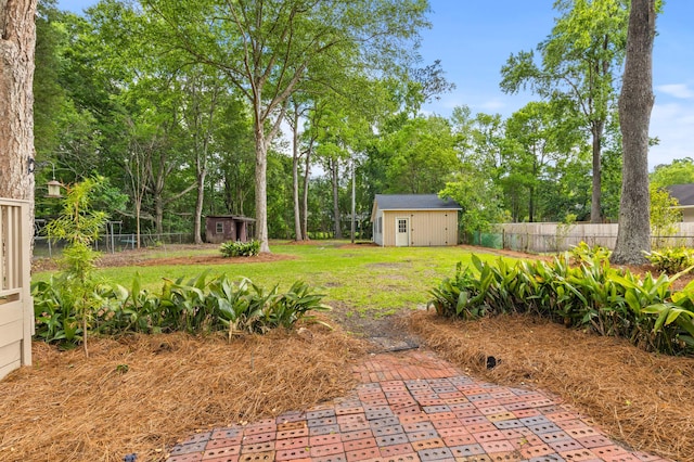 411 Berkeley Dr, Moncks Corner, SC 29461 - view of yard featuring a storage unit, an outbuilding, and view of wooded area