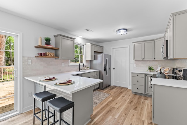 411 Berkeley Dr, Moncks Corner, SC 29461 - kitchen featuring gray cabinets, stainless steel appliances, a peninsula, a sink, and light countertops