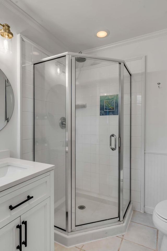 bathroom with tile patterned flooring, vanity, an enclosed shower, ornamental molding, and toilet