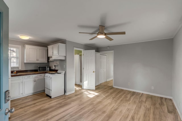 kitchen with white cabinetry, ornamental molding, white range, and light hardwood / wood-style floors