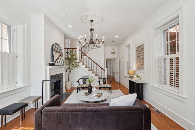 71 E Bay St, Charleston, SC 29401 - living area featuring a chandelier, ornamental molding, stairs, wood finished floors, and baseboards