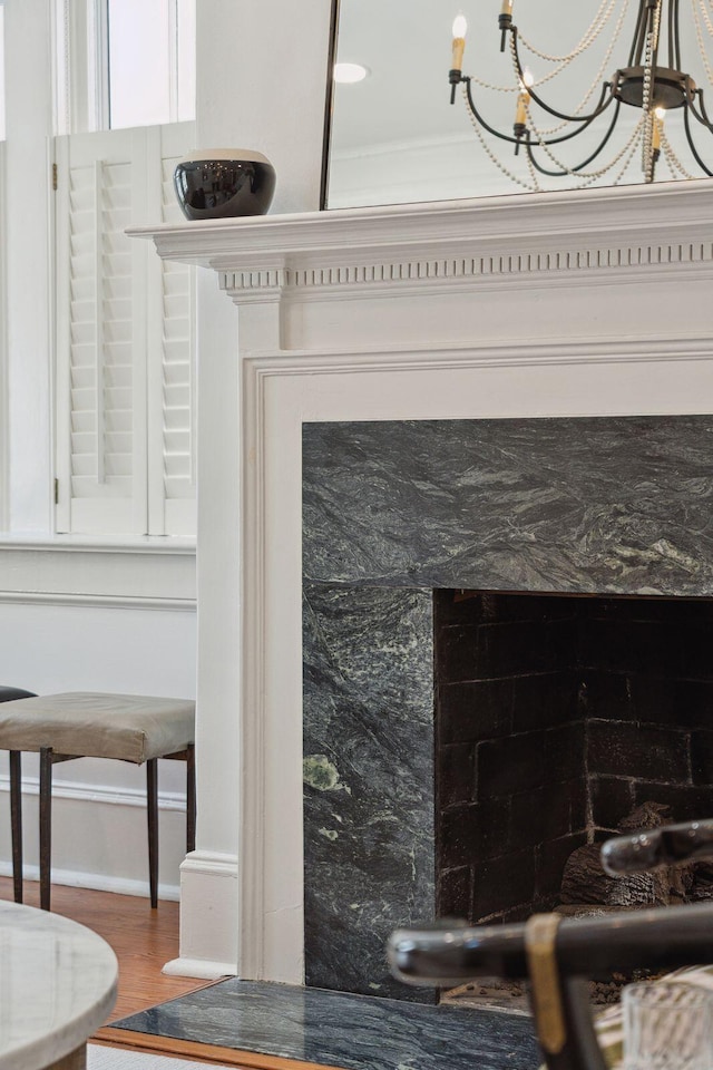 71 E Bay St, Charleston, SC 29401 - detailed view of baseboards, wood finished floors, and a chandelier