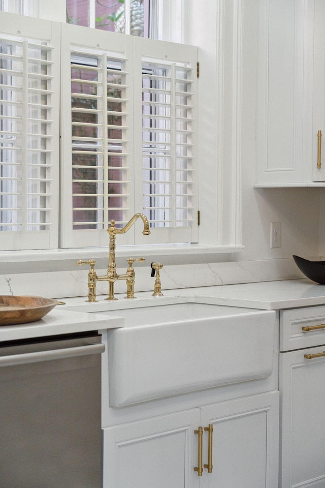 71 E Bay St, Charleston, SC 29401 - kitchen view of stainless steel dishwasher, a sink, light countertops, and white cabinets