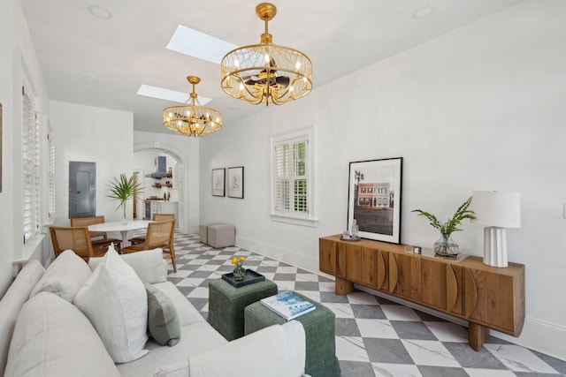71 E Bay St, Charleston, SC 29401 - living area with arched walkways, a chandelier, a skylight, baseboards, and tile patterned floors