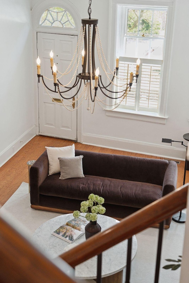 71 E Bay St, Charleston, SC 29401 - living room featuring a chandelier, baseboards, and light wood-style floors