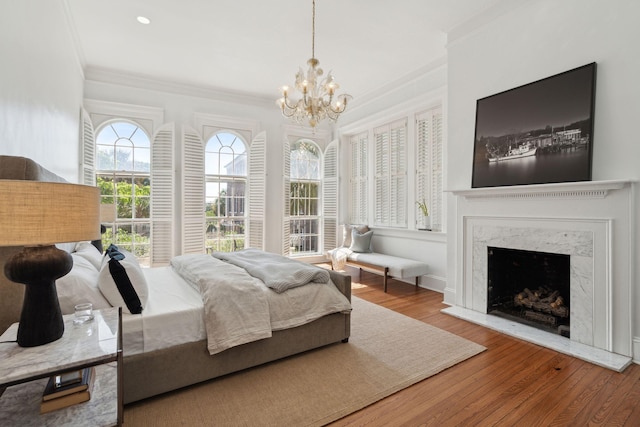 71 E Bay St, Charleston, SC 29401 - bedroom featuring ornamental molding, a chandelier, wood finished floors, and a high end fireplace