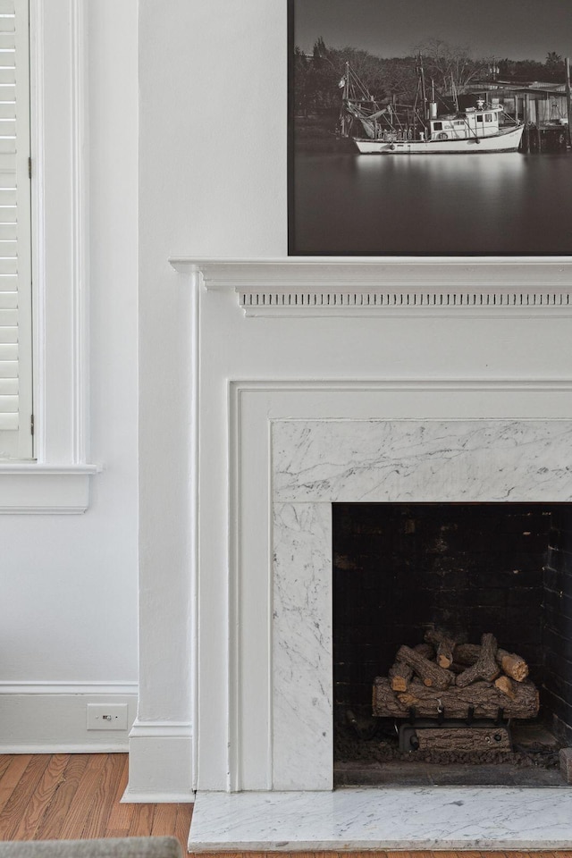 71 E Bay St, Charleston, SC 29401 - detailed view of wood finished floors, a high end fireplace, and baseboards