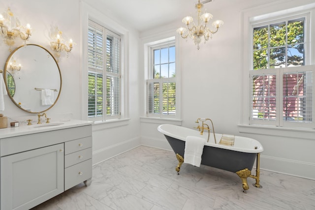 71 E Bay St, Charleston, SC 29401 - full bath with a chandelier, marble look tiles, vanity, and a soaking tub