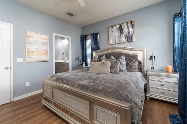 bedroom with ensuite bath, ceiling fan, and dark hardwood / wood-style flooring