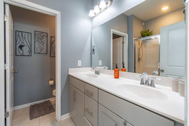 bathroom with tile patterned flooring, an enclosed shower, vanity, and toilet