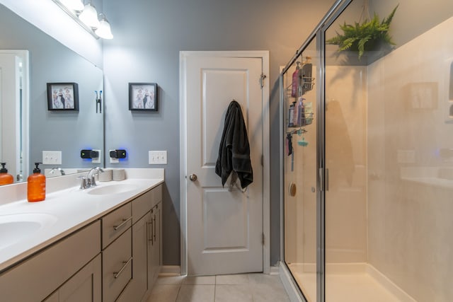 bathroom featuring vanity, tile patterned flooring, and a shower with door