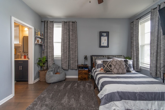 bedroom with ceiling fan, connected bathroom, dark hardwood / wood-style floors, and multiple windows