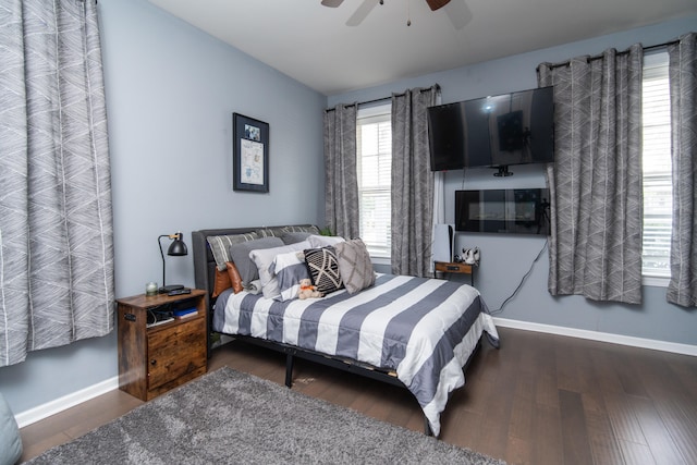 bedroom with dark hardwood / wood-style floors and ceiling fan