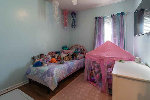 bedroom featuring ceiling fan and multiple windows