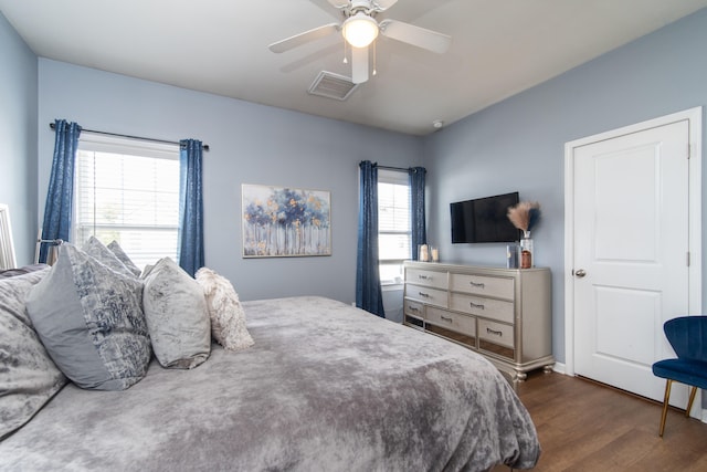 bedroom with ceiling fan and dark hardwood / wood-style flooring