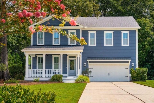 view of front facade with a garage, a porch, and a front lawn