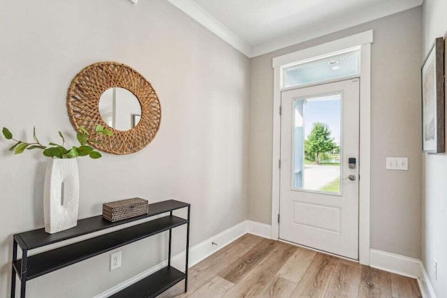 entrance foyer with light wood-type flooring and crown molding