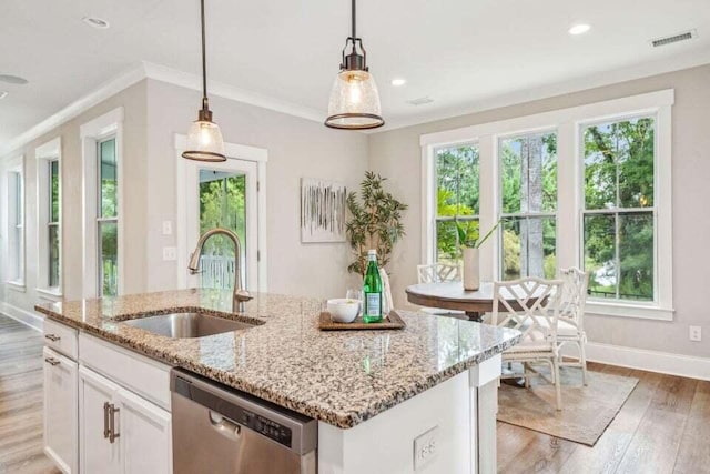 kitchen with sink, an island with sink, stainless steel dishwasher, white cabinetry, and light wood-type flooring