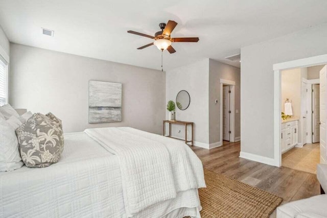 bedroom featuring connected bathroom, ceiling fan, and light hardwood / wood-style flooring