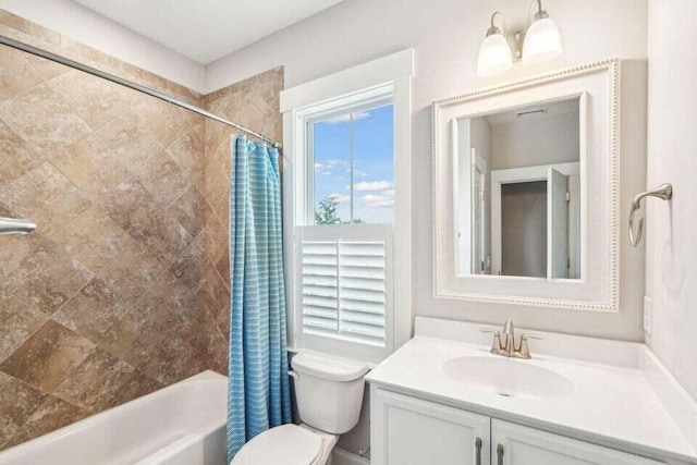 full bathroom featuring shower / bath combo with shower curtain, vanity, and toilet