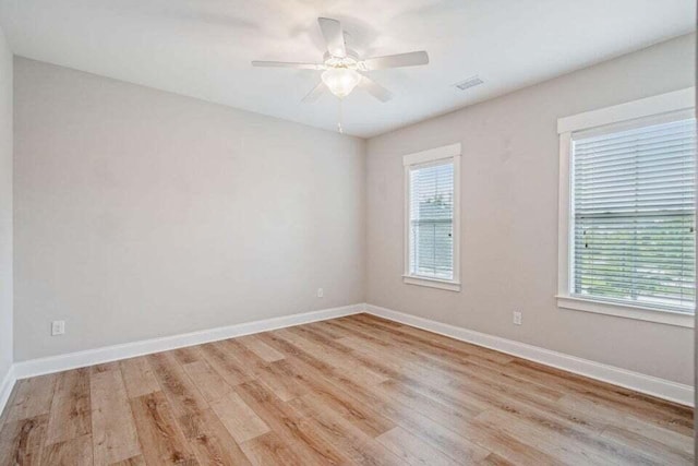 spare room with light hardwood / wood-style floors and ceiling fan