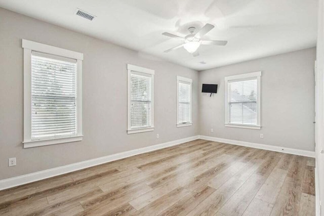 empty room with light hardwood / wood-style flooring and ceiling fan