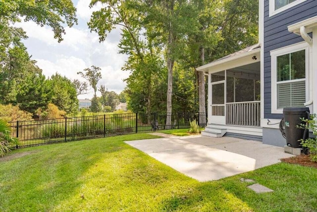 view of yard featuring a patio area and a sunroom