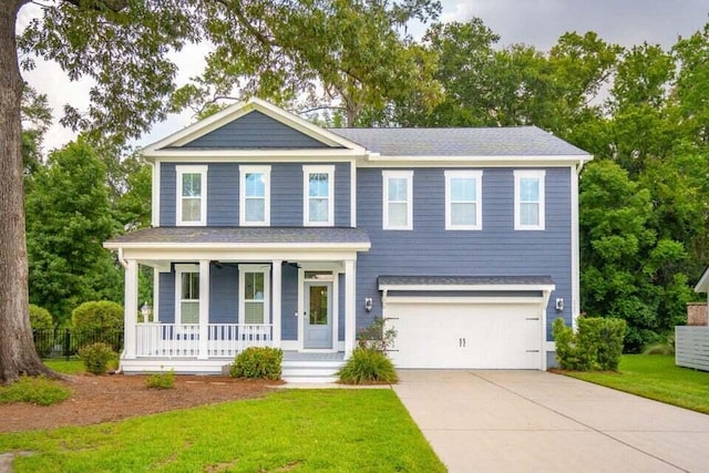 view of front facade with a front lawn, a garage, and covered porch