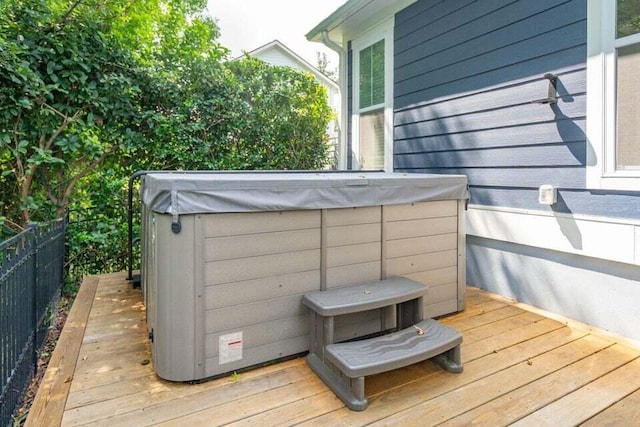 wooden deck with a hot tub