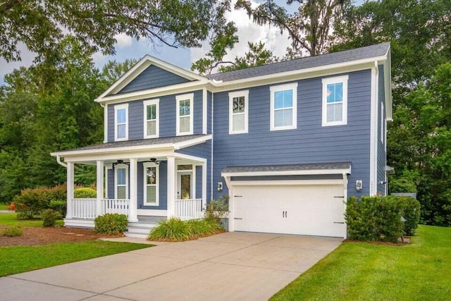 view of front of home featuring a garage, a front yard, and a porch