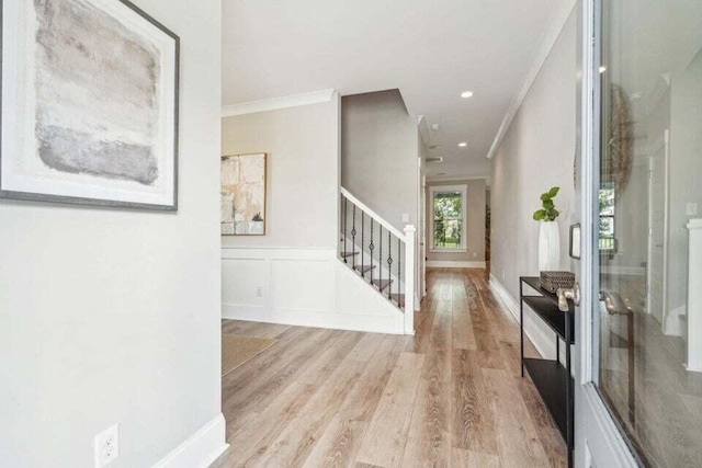 entryway featuring light hardwood / wood-style flooring and ornamental molding