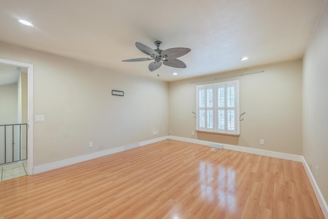 empty room featuring ceiling fan and light hardwood / wood-style floors