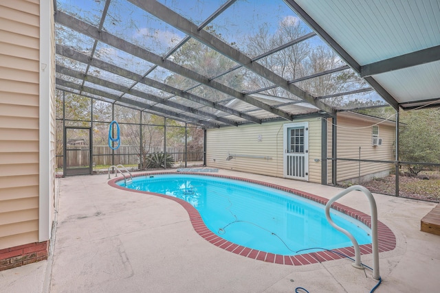 view of swimming pool featuring a lanai and a patio area