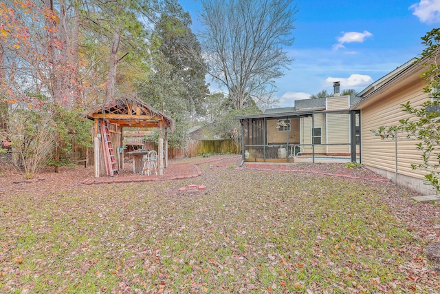 view of yard featuring a swimming pool and a sunroom